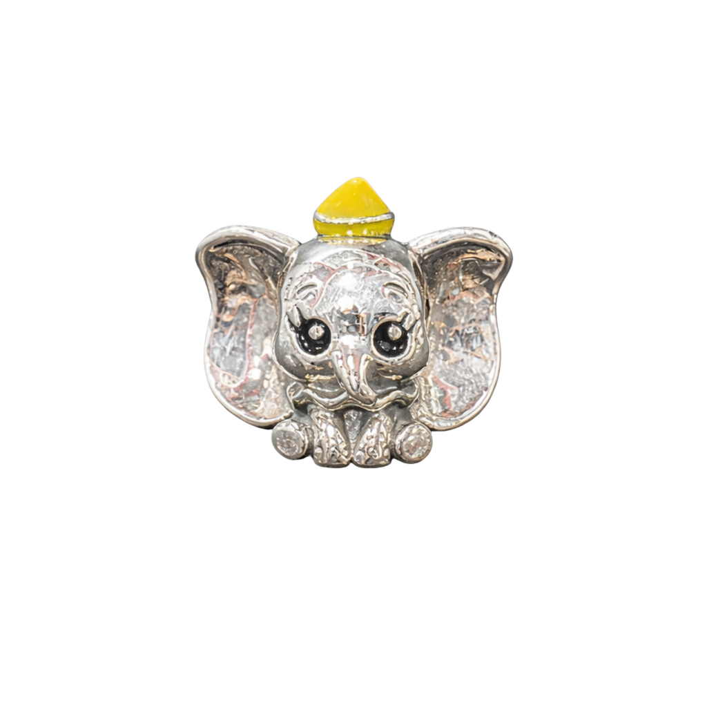 Silver elephant charm with a yellow top on a white background
