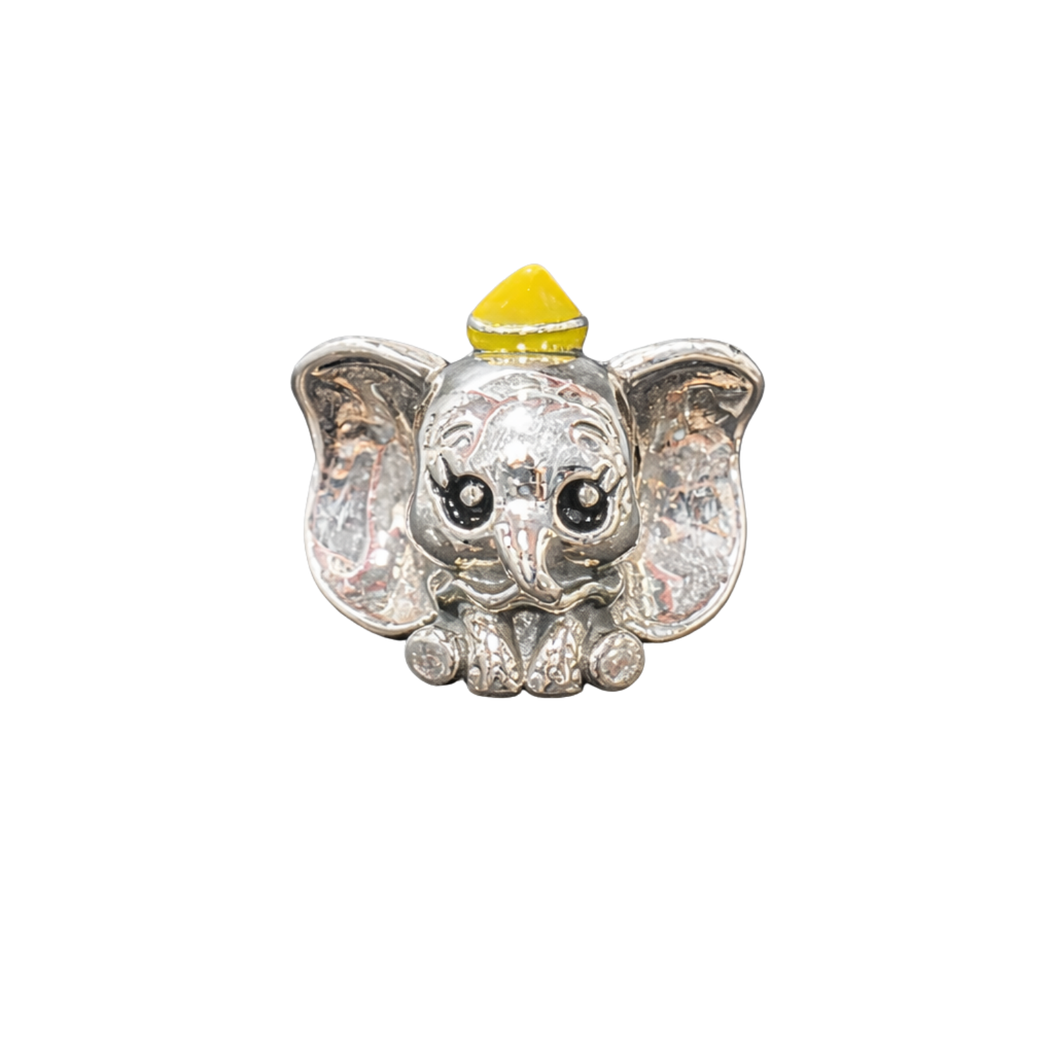 Silver elephant charm with a yellow top on a white background